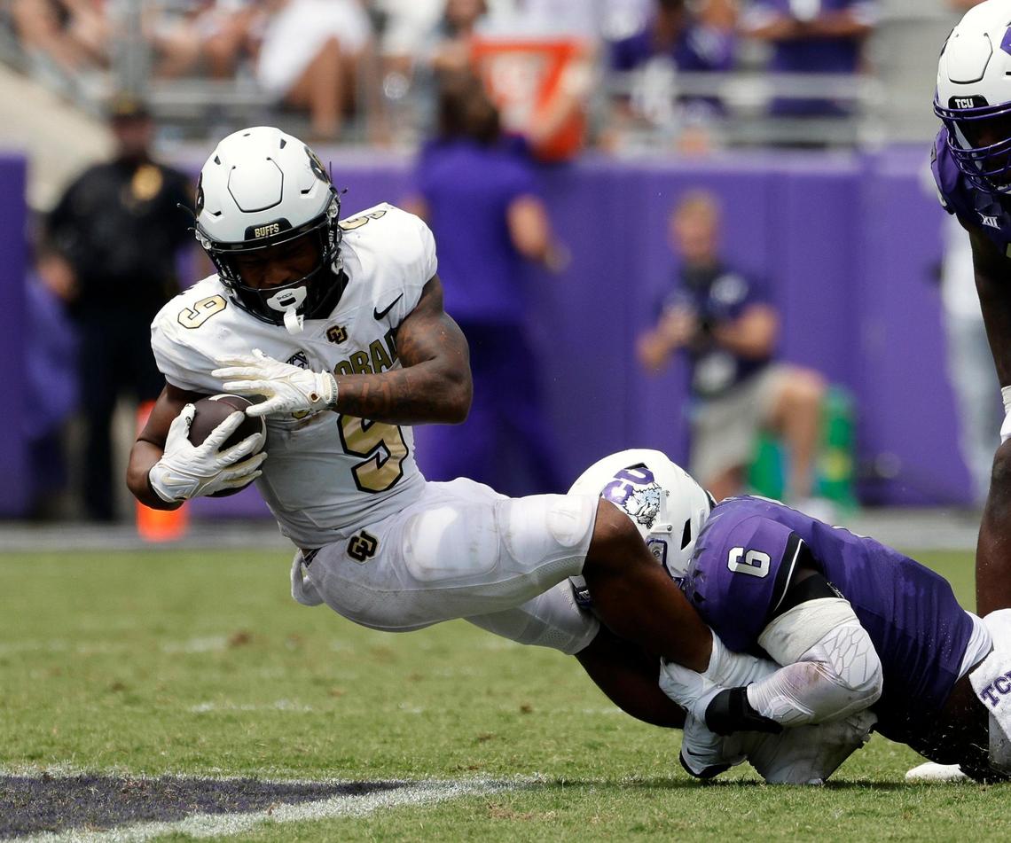 Colorado running back Anthony Hankerson is brought down by TCU linebacker Jamoi Hodge (6) the first half of a NCAA football game at Amon G. Carter Stadium in Fort Worth,Texas, Saturday Sept. 02, 2023. Colorado led 17-14 at the half. (Special to the Star-Telegram Bob Booth)