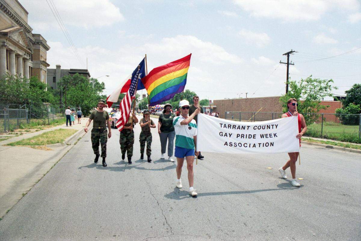 June 3, 1990: Members of the Tarrant County Gay Pride Week Association carry a banner in front of a color guard of gay and lesbian veterans during the Gay Pride Week. They’re marching north on South Jennings Avenue, with the Fort Worth High School building visible at left.