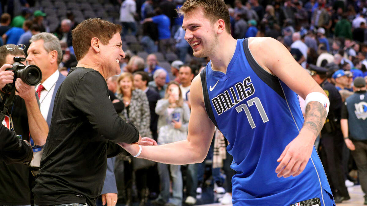 Dallas Mavericks owner Mark Cuban shakes hands with Luka Doncic after a 2019 game.