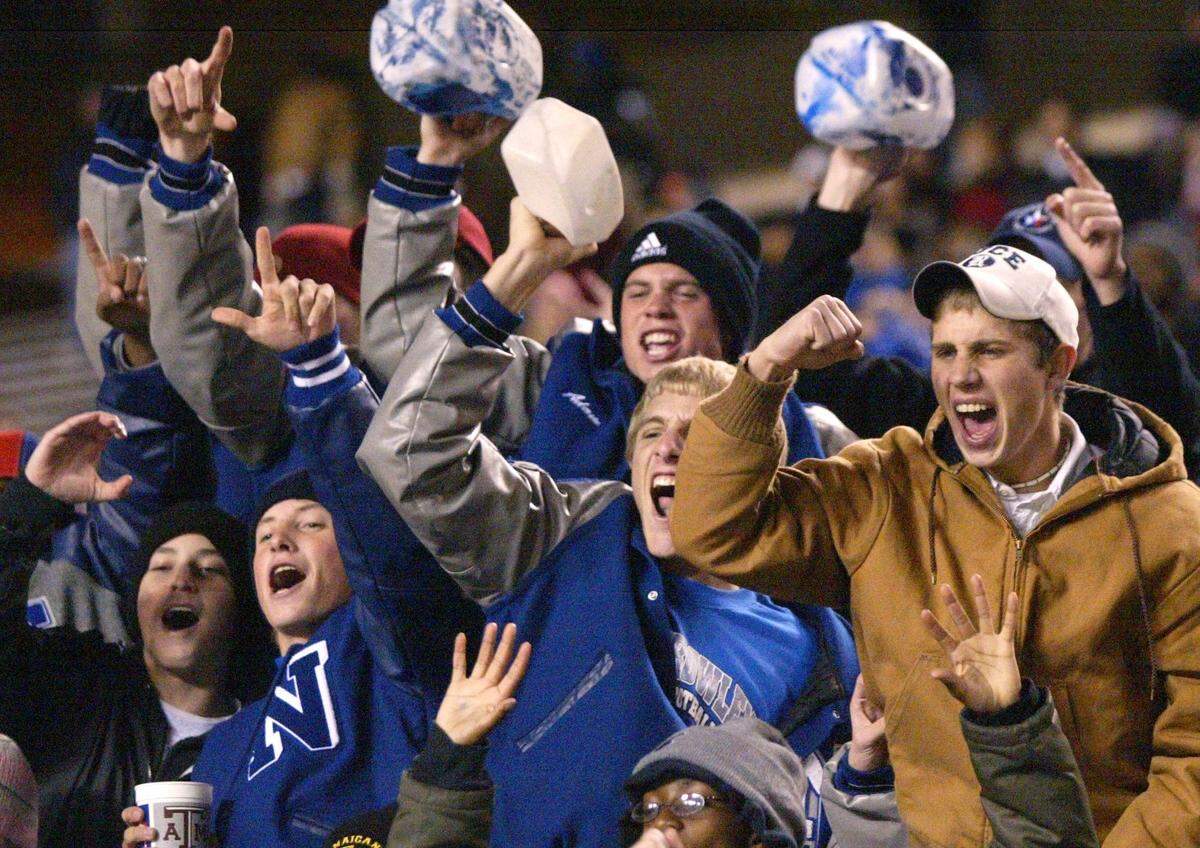 North Crowley students celebrate the victory as time runs out late in the 4th quarter. North Crowley wins 20-6. Texas high school football state championship game. North Crowley High vs Bay City High for the District 4A Division 1 state title at Kyle Field in College Station, Texas, Saturday, December 13, 2003. (Star-Telegram/Ron Jenkins)