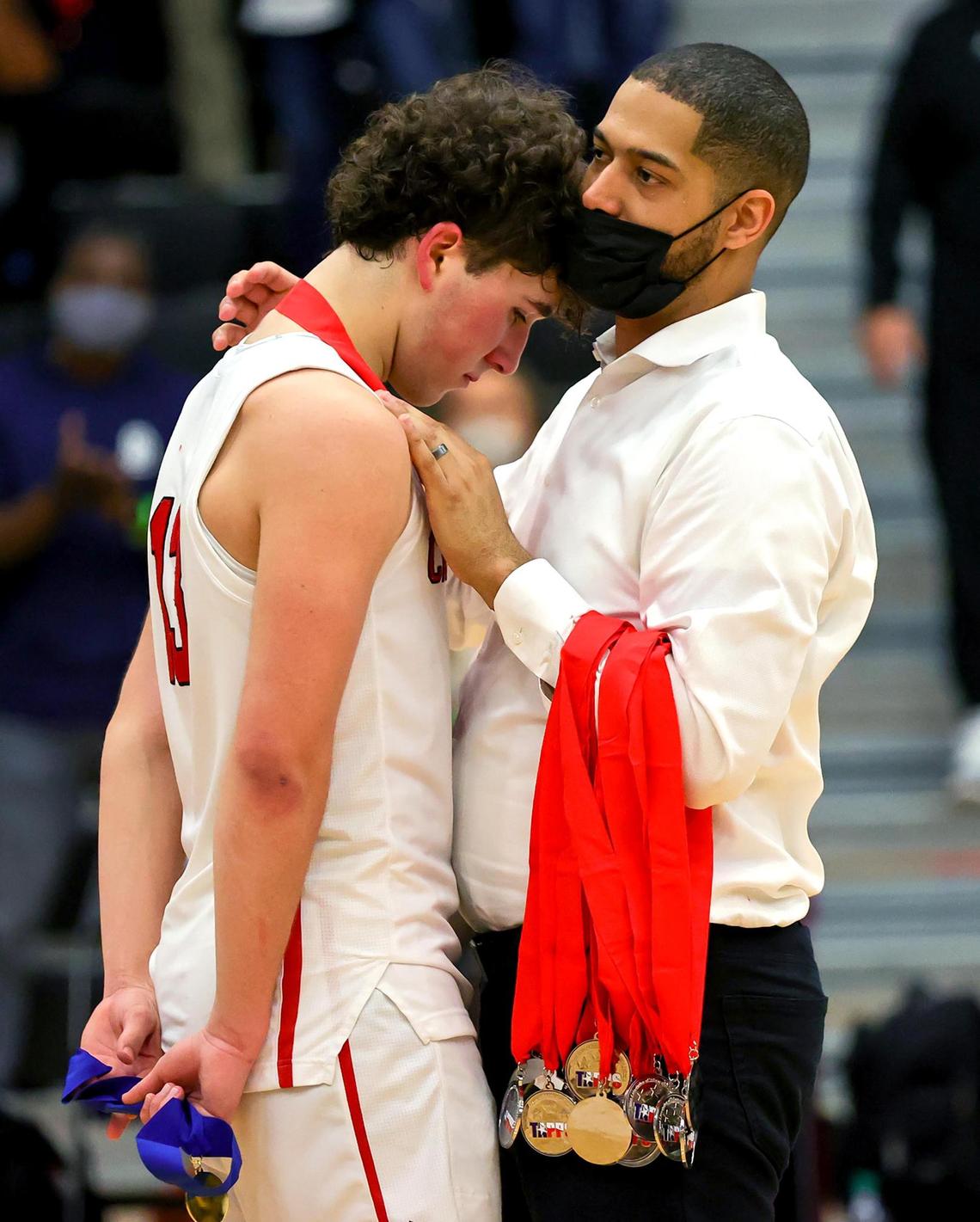 Fort Worth Christian head coach Stephen Mawire tries to console his guard Alex Bossinakis after losing to The Woodlands Christian Academy, 60-47, in the 5A TAPPS Boys Basketball State Championship game played on March 12, 2021 at College Station High School in College Station, TX. (Steve Nurenberg Special to the Star-Telegram)