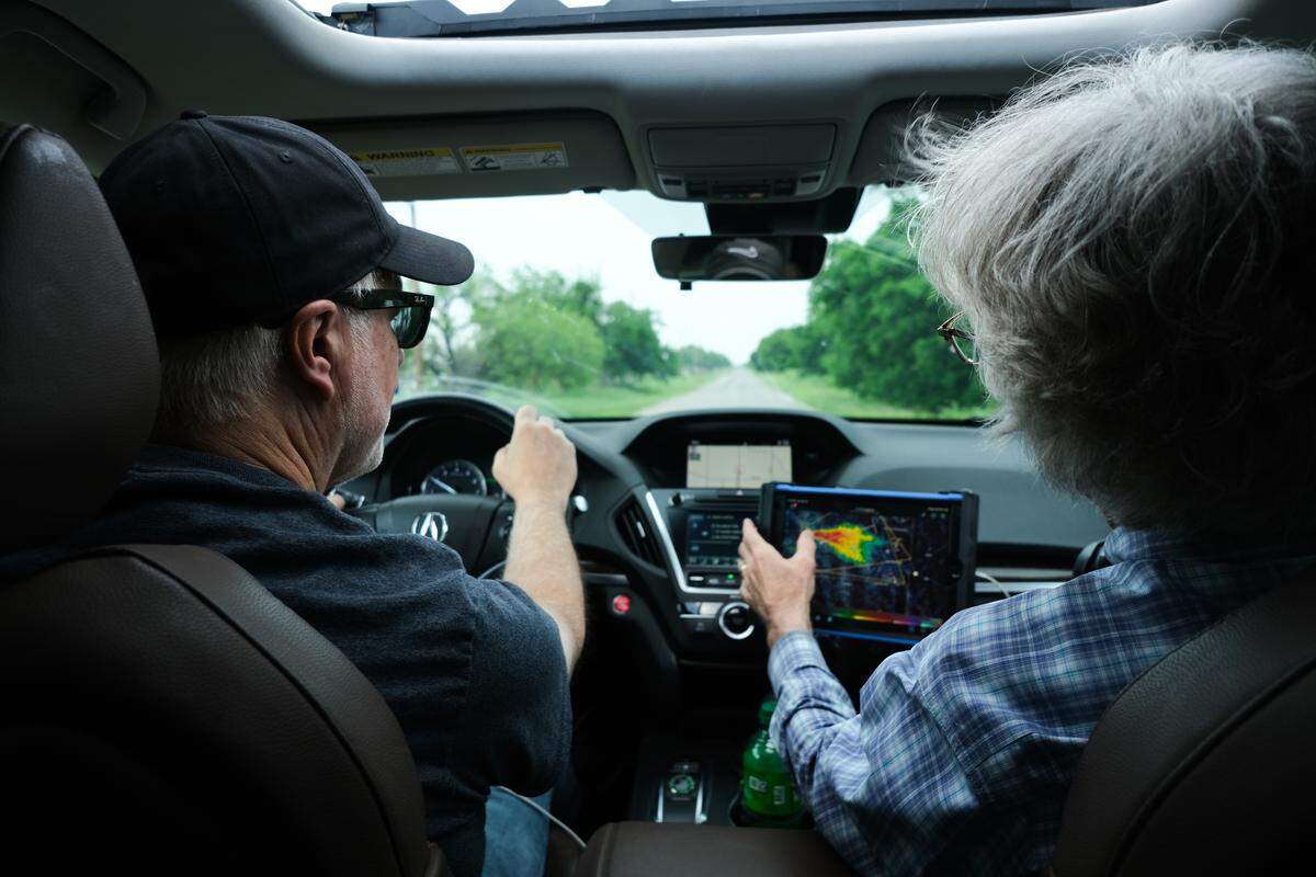 Storm chasers Martin Lisius and Steve George checked a weather radar while following a storm system near Iowa Park, Texas, on April 26, 2026.