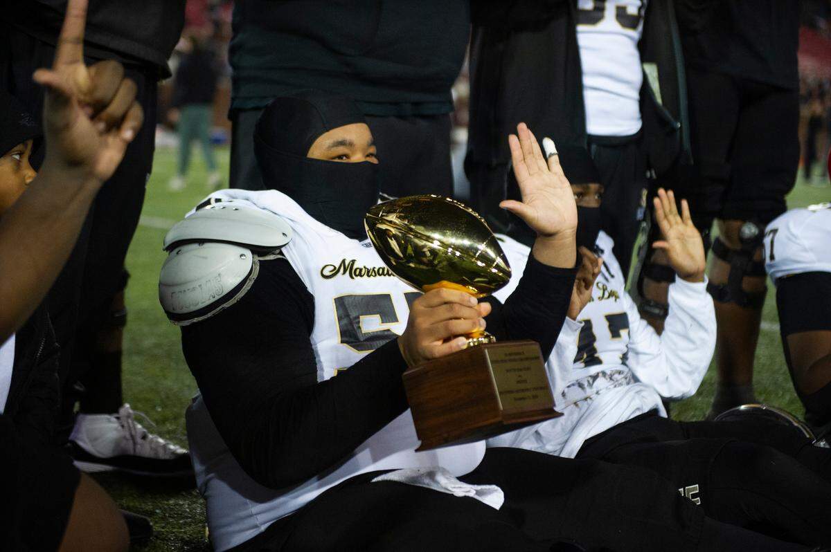 South Oak Cliff offensive linemen Brison Brooks (55) poses with the the Class 5A Division II semifinal trophy after defeating Argyle in a Class 5A Division II state semifinal on Friday, Dec. 13, 2024 at Gerald J. Ford Stadium in University Park, Texas.