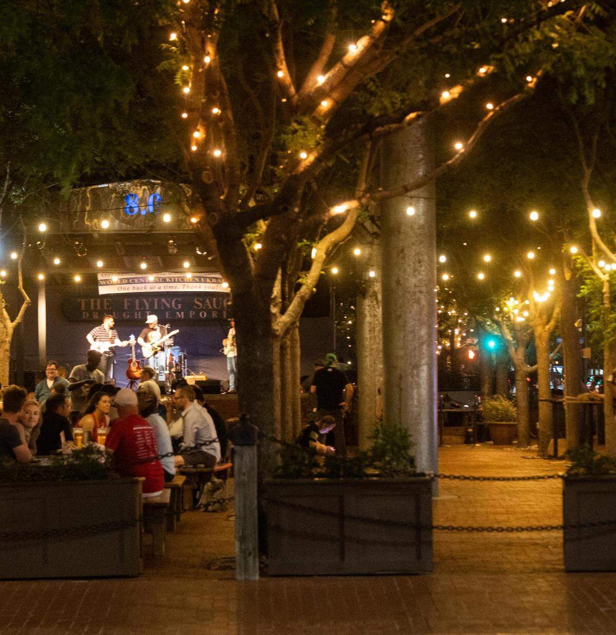 People listen to a band playing at Flying Saucer on Saturday, May 7, 2022, in downtown Fort Worth.