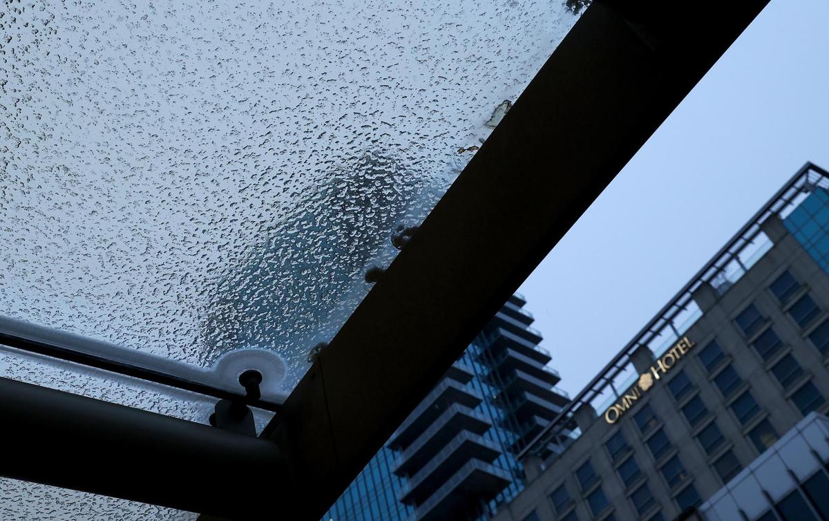 A mix of sleet and snow accumulated on a glass awning at the entrance of the Fort Worth Convention Center on Houston Street in downtown Fort Worth on Thursday, Jan. 9, 2025. A winter storm warning is in effect for North Texas.