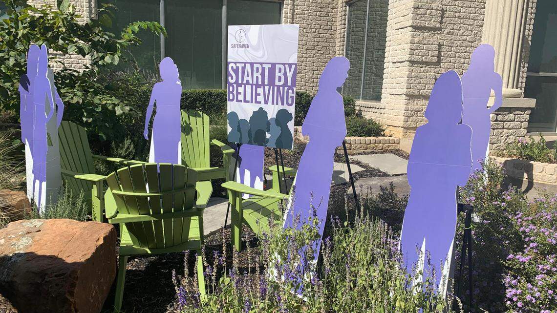 Seven cardboard cutouts stand in the sun outside SafeHaven’s office in Arlington. The cutouts represent the seven women who were killed by their partners or former partners in Tarrant County in 2021, according to a report from the Tarrant County Adult Fatality Review team.