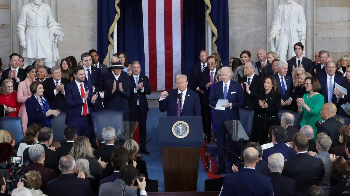 Jan 20, 2025; Washington, DC, USA; U.S. President Donald Trump raises his fist after taking the oath on the day of his Presidential Inauguration at the Rotunda of the U.S. Capitol in Washington, U.S. January 20, 2025. REUTERS/Fabrizio Bensch/Pool Mandatory Credit: Fabrizio Bensch-Pool via Imagn Images
