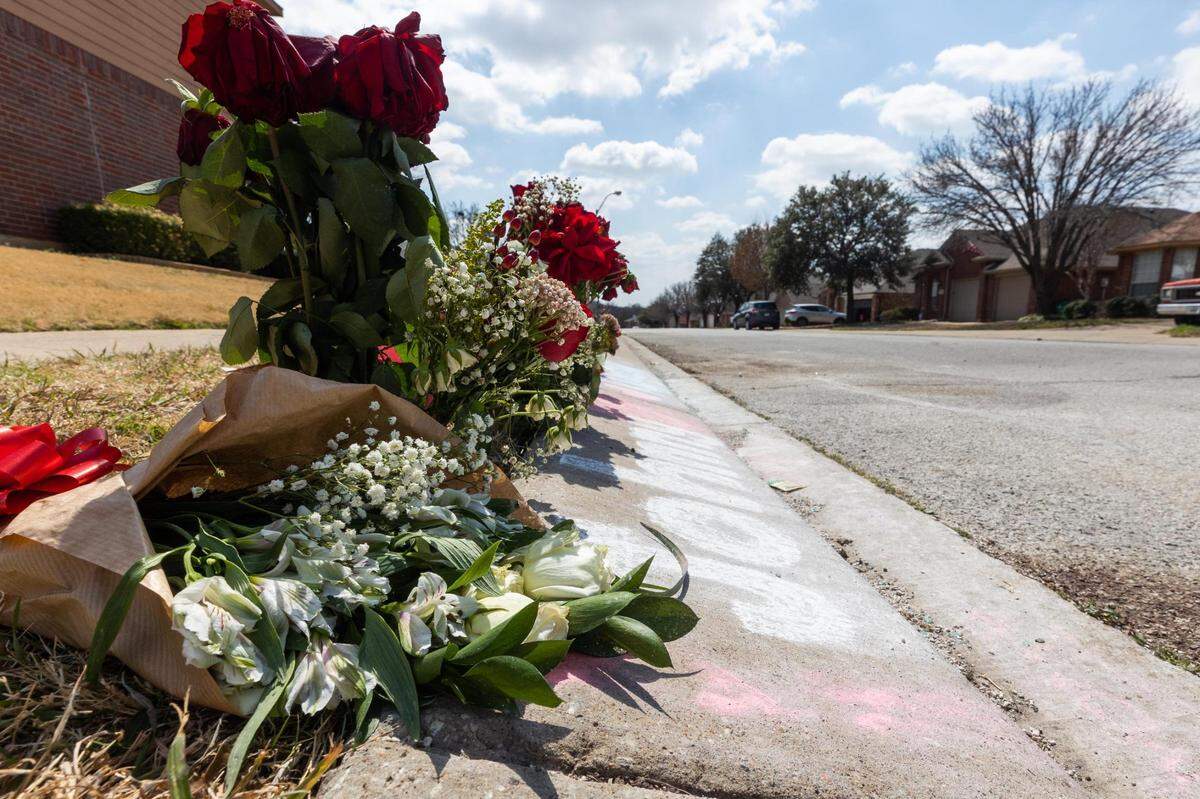 A memorial with names and flowers is left at the site where two teenagers were fatally shot Saturday, March 12, in a residential neighborhood in Watauga.