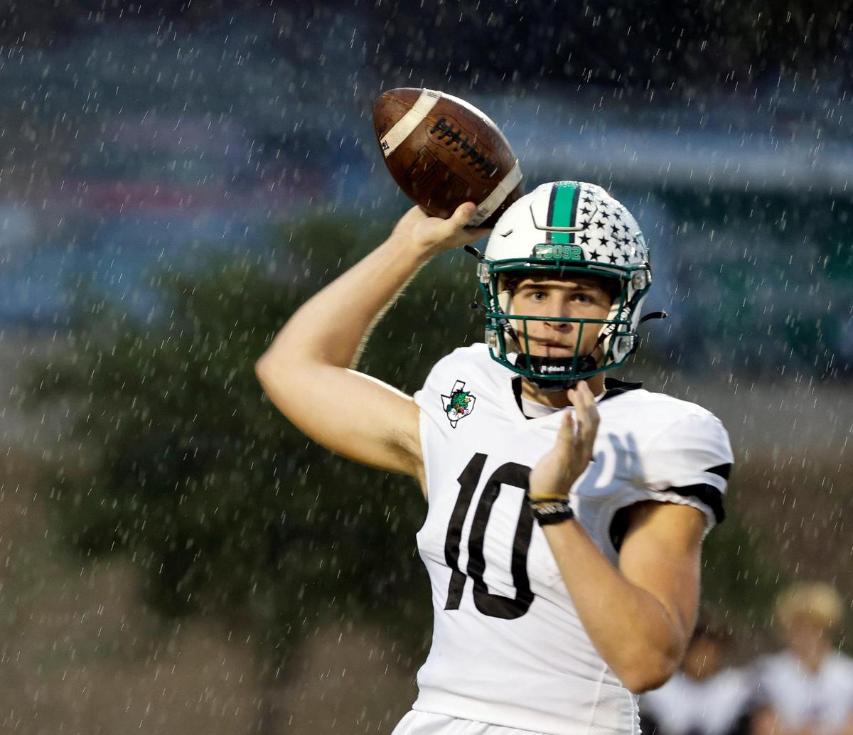Carroll quarterback Graham Knowles (10) makes a sidelines toss in the rain in the first half of a UIL high school football game at Keller ISD Stadium in Keller, Texas, Thursday, Sept. 14, 2023.