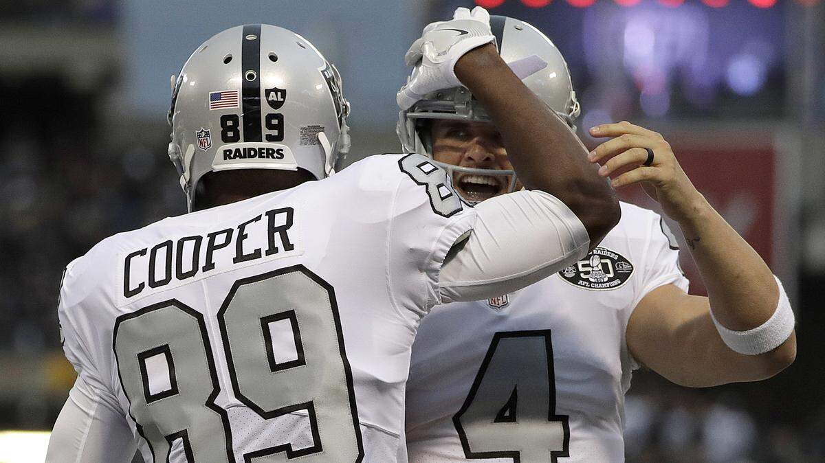Oakland Raiders wide receiver Amari Cooper (89) and quarterback Derek Carr (4) celebrate after connecting on a touchdown pass against the Kansas City Chiefs during the first half of an NFL football game in Oakland, Calif., Thursday, Oct. 19, 2017.