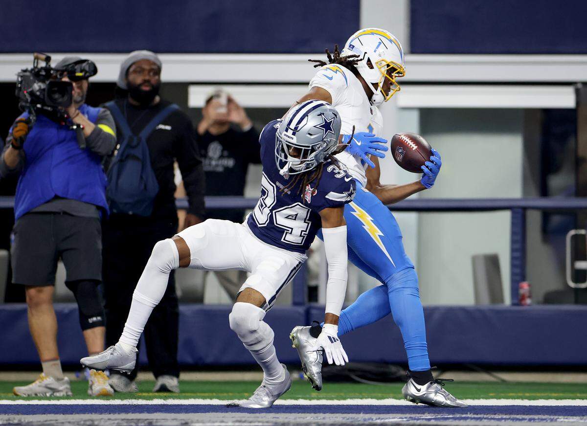 Los Angeles Chargers wide receiver Quentin Johnston beats Dallas Cowboys cornerback Shavon Revel to complete a pass in the end zone for touchdown during the first quarter on Sunday, Dec. 21, 2025, at AT&T Stadium.