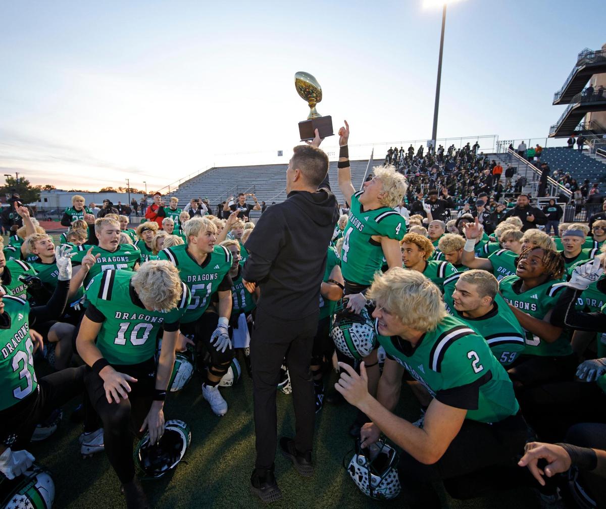 Southlake head coach Riley Dodge presents the trophy to the team after winning the UIL District 6A D2 Regional Semi-Finals football game at Joy and Ralph Ellis Stadium in Irving, Texas, Nov. 29, 2024.