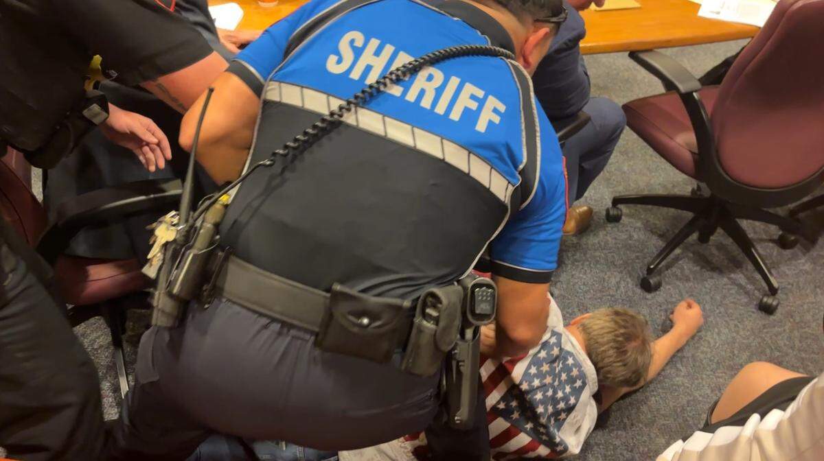 Charlie Hermes, a professor at UT Arlington, is removed from the Tarrant County Commissioners Court on Jan. 28 after County Judge Tim O’Hare determined he had broken the court’s rules on decorum by clapping and verbalizing during the session.