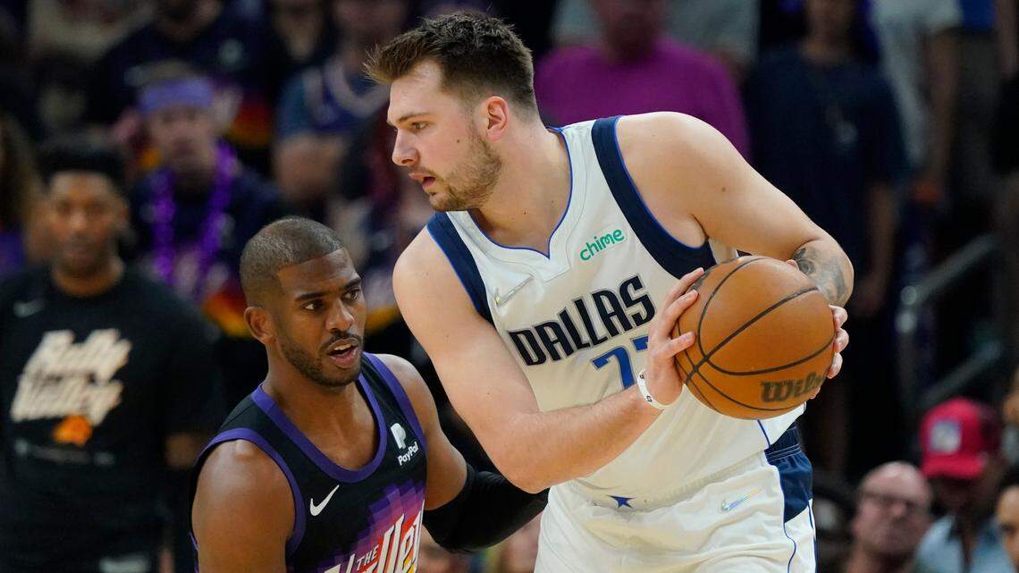 Phoenix Suns guard Chris Paul defends against Dallas Mavericks guard Luka Doncic during the first half of Game 7 Sunday night. Doncic leads all scorers with 27 points at halftime to lead the Mavs to a 57-27 halftime advantage.