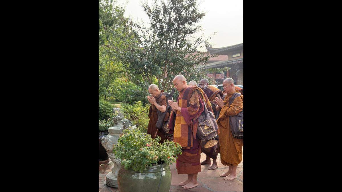 Bhikkhu Pannakara and fellow monks pray before beginning their walk for peace in October in Fort Worth.