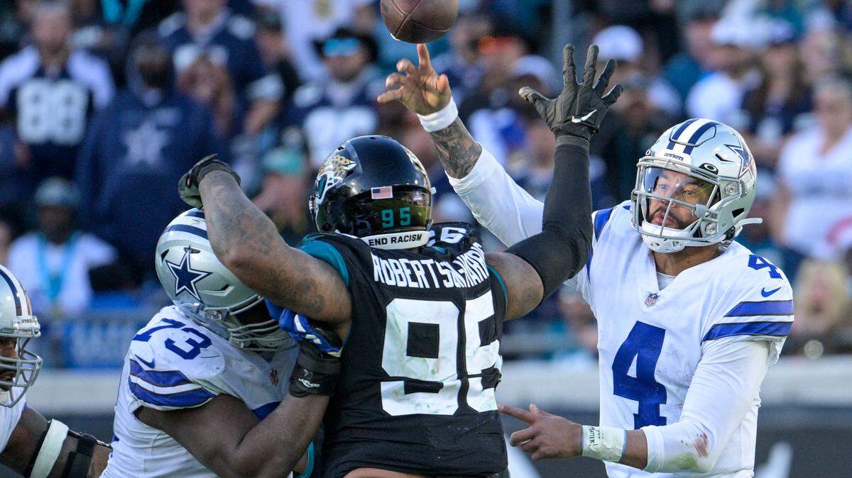 Dallas Cowboys quarterback Dak Prescott (4) throws an interception pass during overtime in an NFL football game against Jacksonville Jaguars.