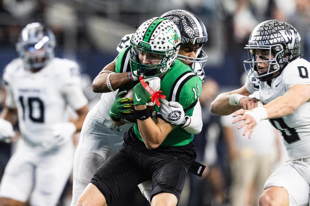 Southlake Carroll wide receiver Brock Boyd (11) is tackled by Vandegrift safety Tobias Gray (22) after a reception in the first half of the UIL 6A Division II championship game at AT&T Stadium in Arlington on Saturday, Dec. 21, 2024.