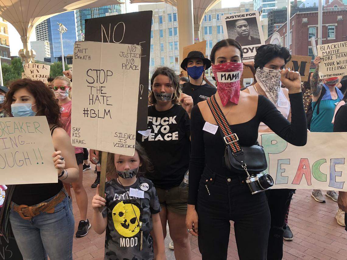 Protesters hold fists in the air outside a restaurant in Sundance Square during a silent protest on Sunday, June 14.
