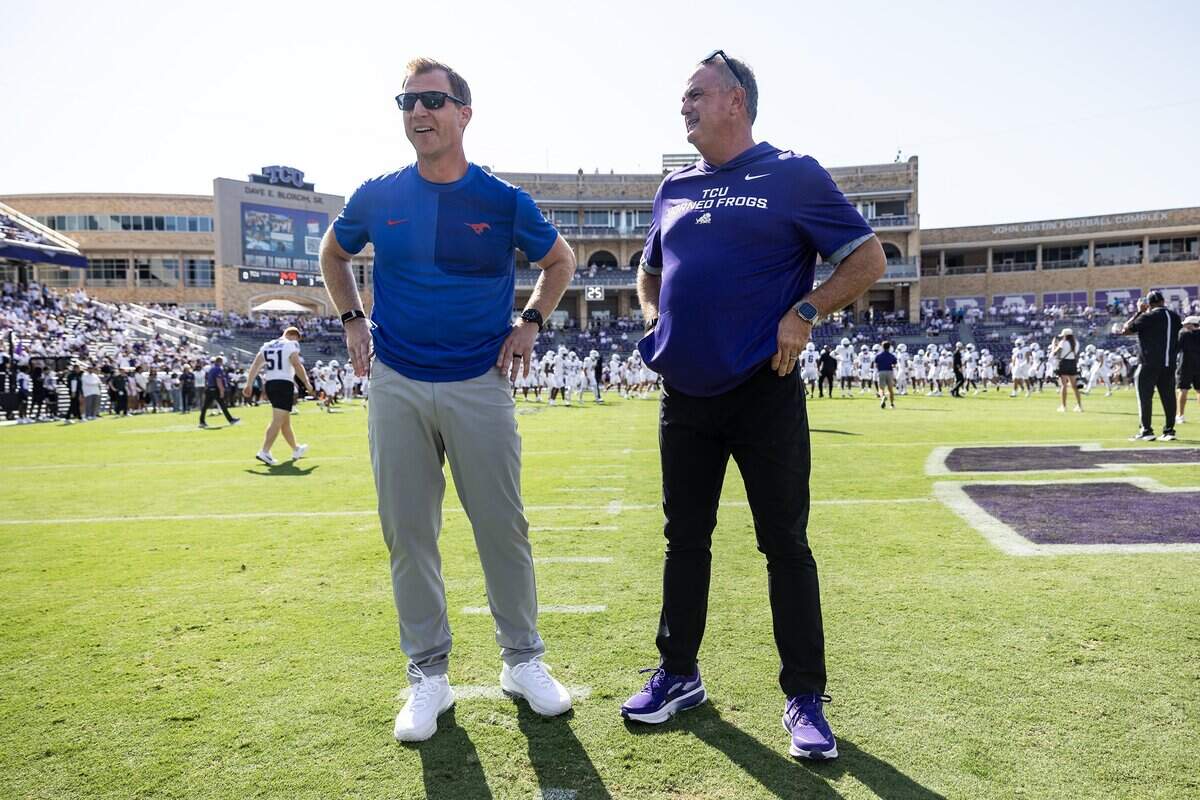 SMU Head Coach Rhett Lashlee, left, and TCU Head Coach Sonny Dykes, right, have a conversation prior to an NCAA football game between TCU and SMU at Amon G. Carter Stadium in Fort Worth on Saturday, Sept. 20, 2025.