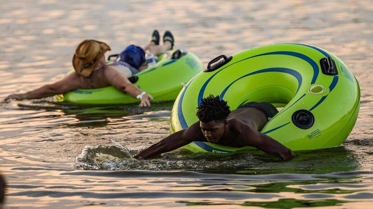 Brandon Ford, 14, uses his tube to swim in the water during the Rockin’ The River Live on the Trinity Concert event at the Panther Island Pavilion in Fort Worth on Thursday, July 13, 2023.