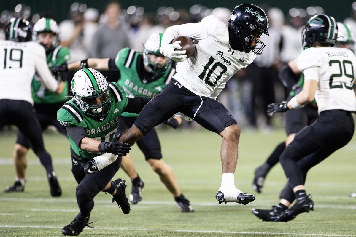 Prosper wide receiver Marcus McCoy (10) jumps to evade a tackle on a punt return in the second half of the UIL Division II Regional playoff game at Choctaw Stadium in Arlington on Friday, Nov. 28, 2025.