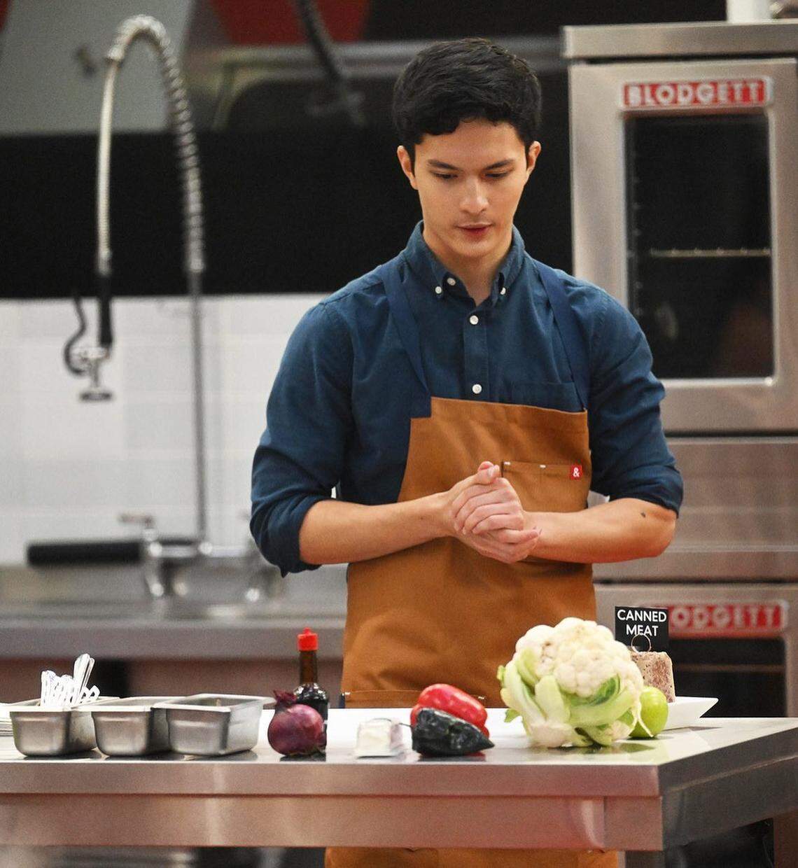 Arlington native Preston Nguyen eyes his ingredients on the set of “Next Level Chef”.