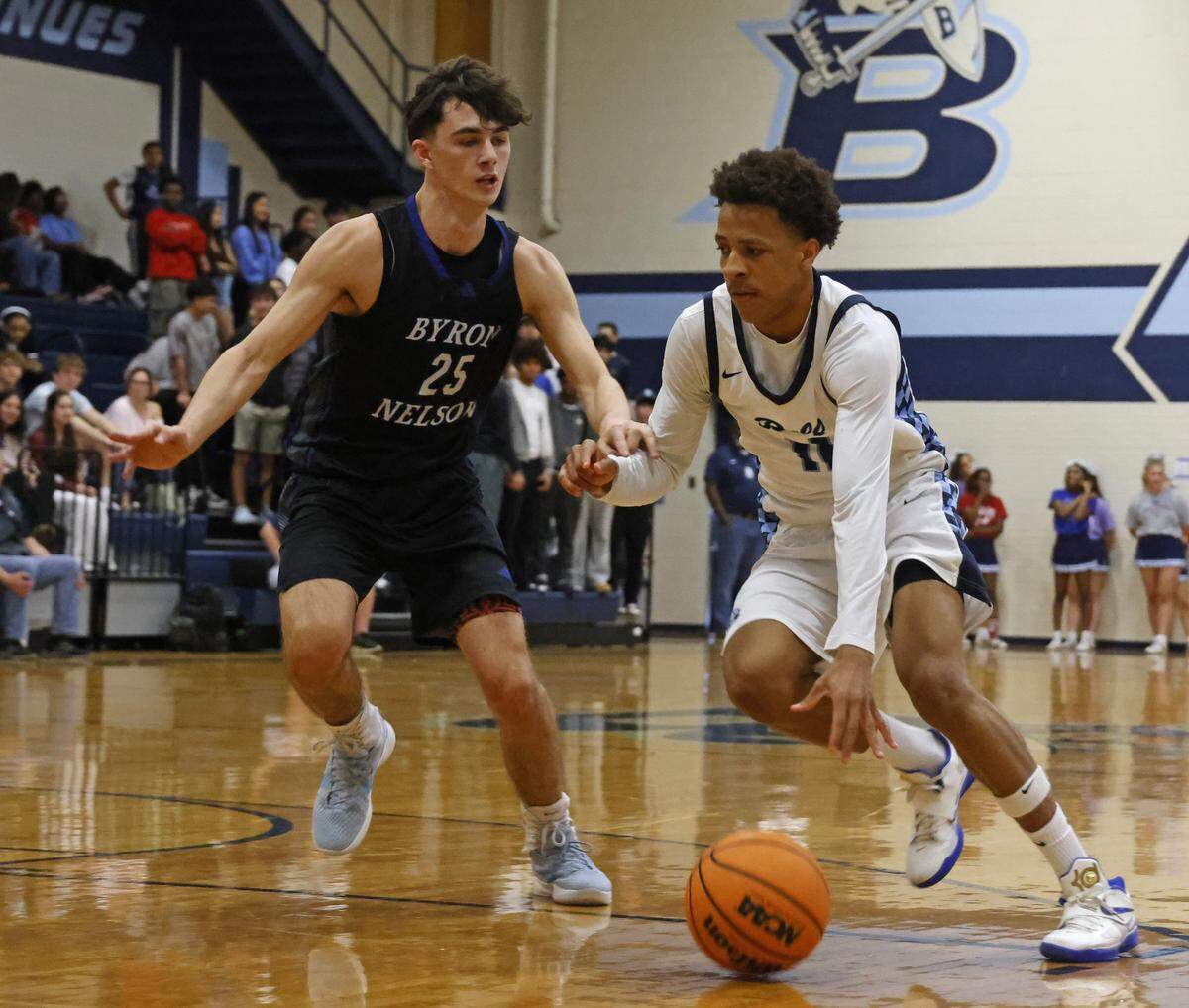 L.D. Bell guard Roman Washington (11) brings the ball into the key against Byron Nelson guard Braylon Edwards (25) during the first half of a boys UIL basketball game between Byron Nelson and L.D. Bell at L.D. Bell High School in Hurst, Texas, Friday Feb. 06, 2026