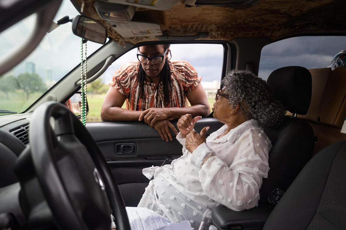 Amani Latimer Burris chats with Opal Lee while dropping off grocery boxes for farm manager Greg Joel on Sept. 1 at Opal’s Farm in Fort Worth.