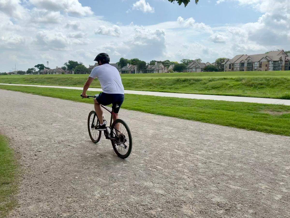 Charles Devilver bikes along the Trinity Trail after taking a short ten minute break from his ride.