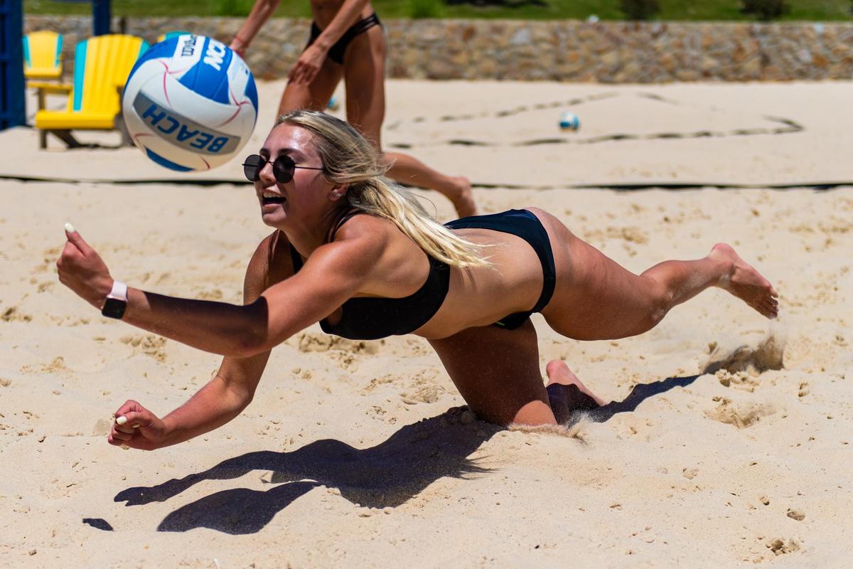 Kate Lang diving to dig the ball while playing beach volleyball in Fort Worth in 2019.