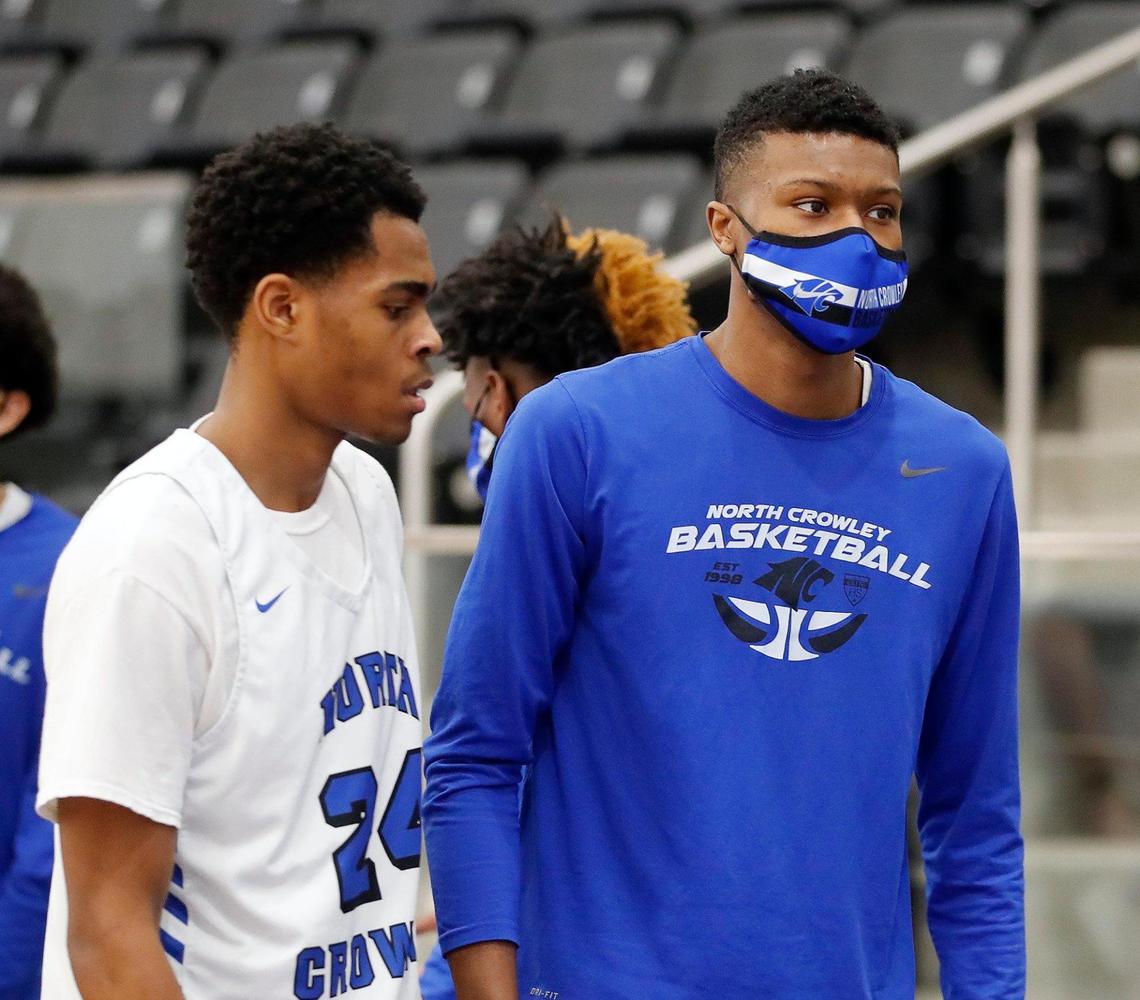 North Crowley forward Mike Hall (21) leaves the court with team mate Trey Davis (24) in a high school basketball game at North Crowley High School in Crowley, Texas, Tuesday, Jan. 19, 2021. North Crowley defeated Haltom 72-55. (Special to the Star-Telegram Bob Booth)