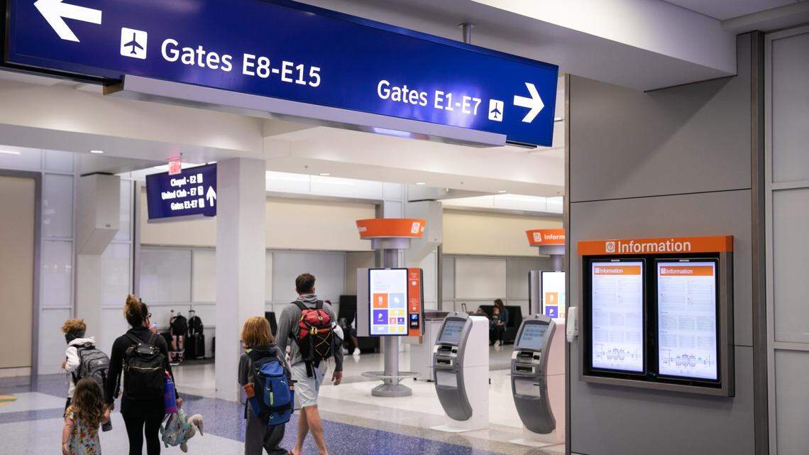 Passengers walk through Terminal E at Dallas-Fort Worth International Airport.