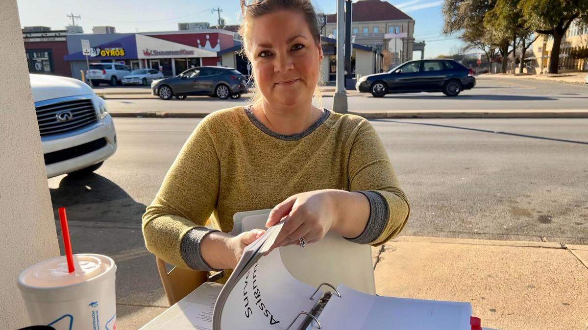 Hollie Plemmons, a Fort Worth parent that has been questioning the school over surveys given to students shows a binder she has compiled on the topic, including every survey given to students in a year.