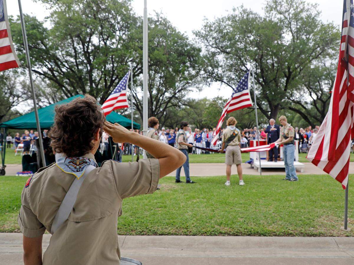 May 30, 2022: Members of Longhorn Council troop 50, including Drake Callaway, 17, Carson Callaway, 15, Rob Muckleroy, 15, Samuel Meyn, 17, and Nickolas Brown, 15, retire the flag after the 93rd Fort Worth Memorial Day Service at Mount Olivet Cemetery.
