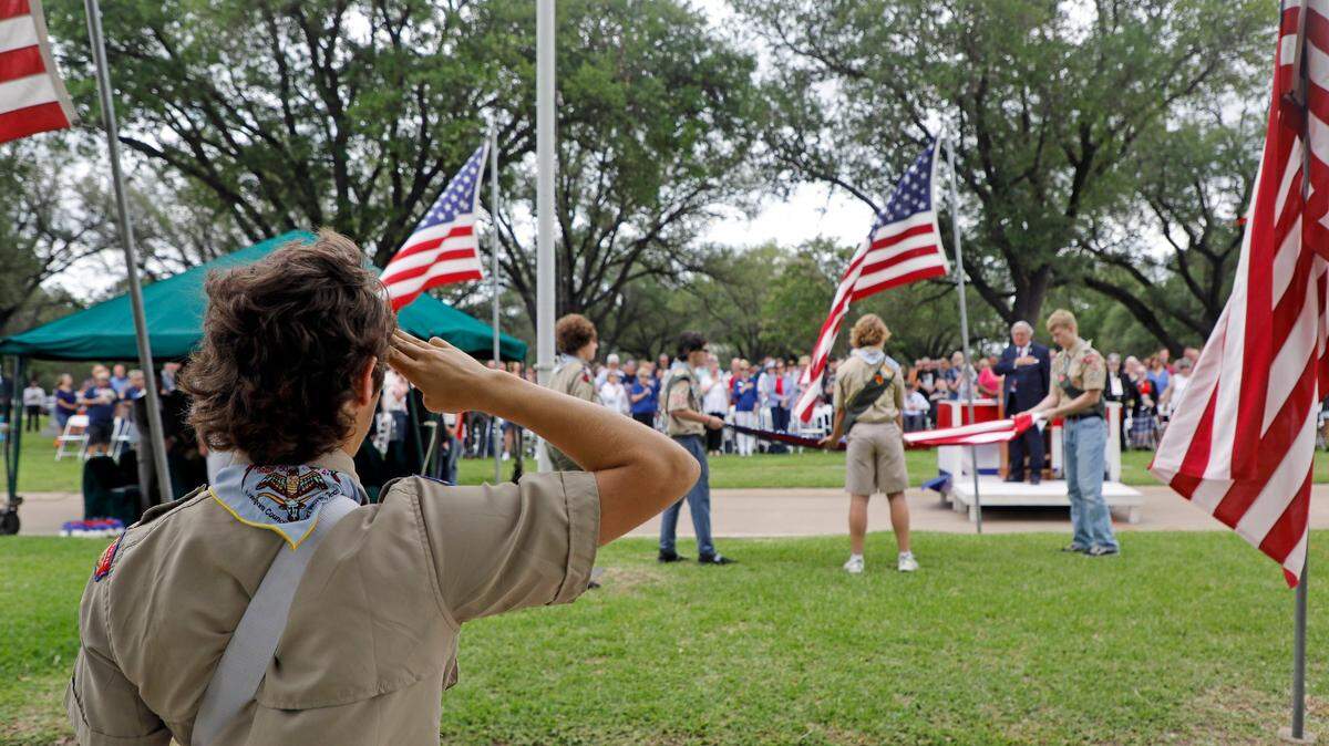 May 30, 2022: Members of Longhorn Council troop 50, including Drake Callaway, 17, Carson Callaway, 15, Rob Muckleroy, 15, Samuel Meyn, 17, and Nickolas Brown, 15, retire the flag after the 93rd Fort Worth Memorial Day Service at Mount Olivet Cemetery.