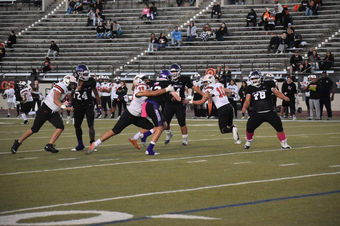 Haltom’s Gerardo Tejeda (99) sacks Paschal’s Will Henry during a football game at Farrington Field in Fort Worth, Texas, Friday, Oct. 15, 2021, Haltom won 51-20. (Michelle Escalante/Special to the Star-Telegram)