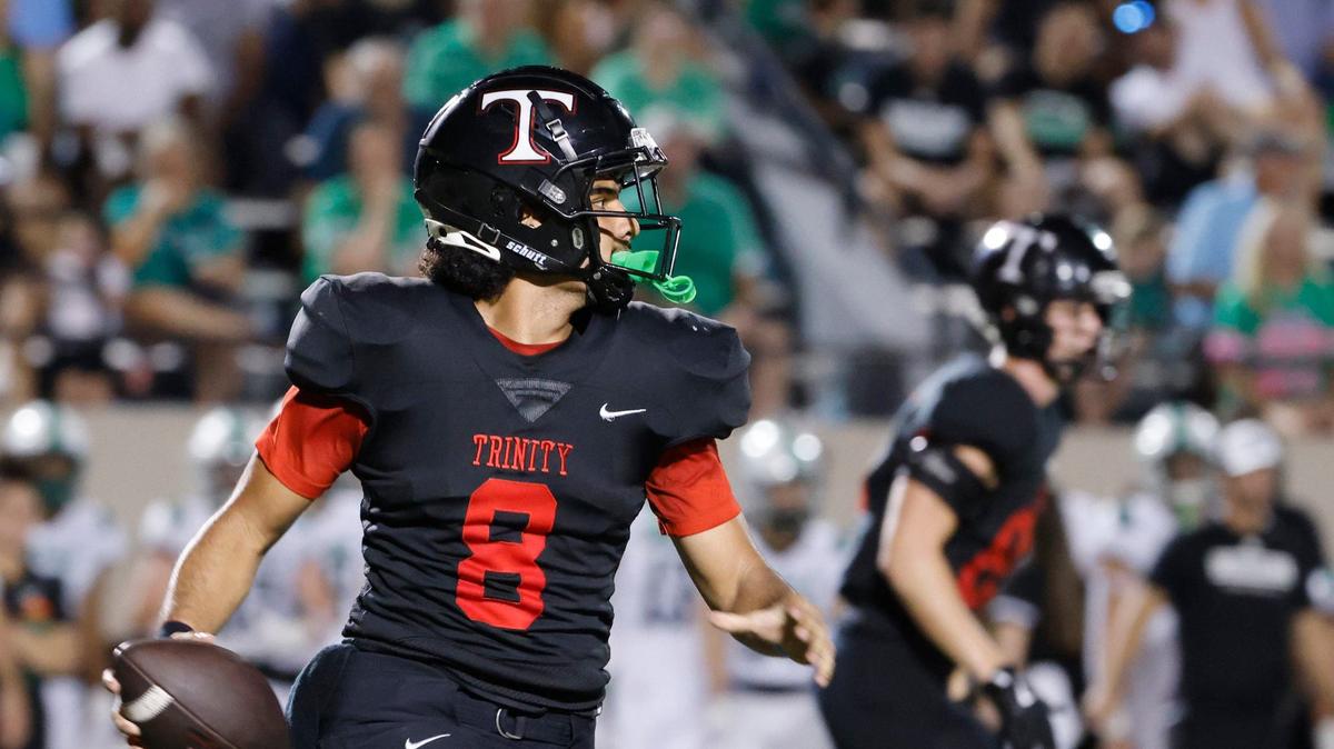 Trinity quarterback TJ Tupou (8) and the Trojans are moving up in the Class 6A rankings despite a loss.