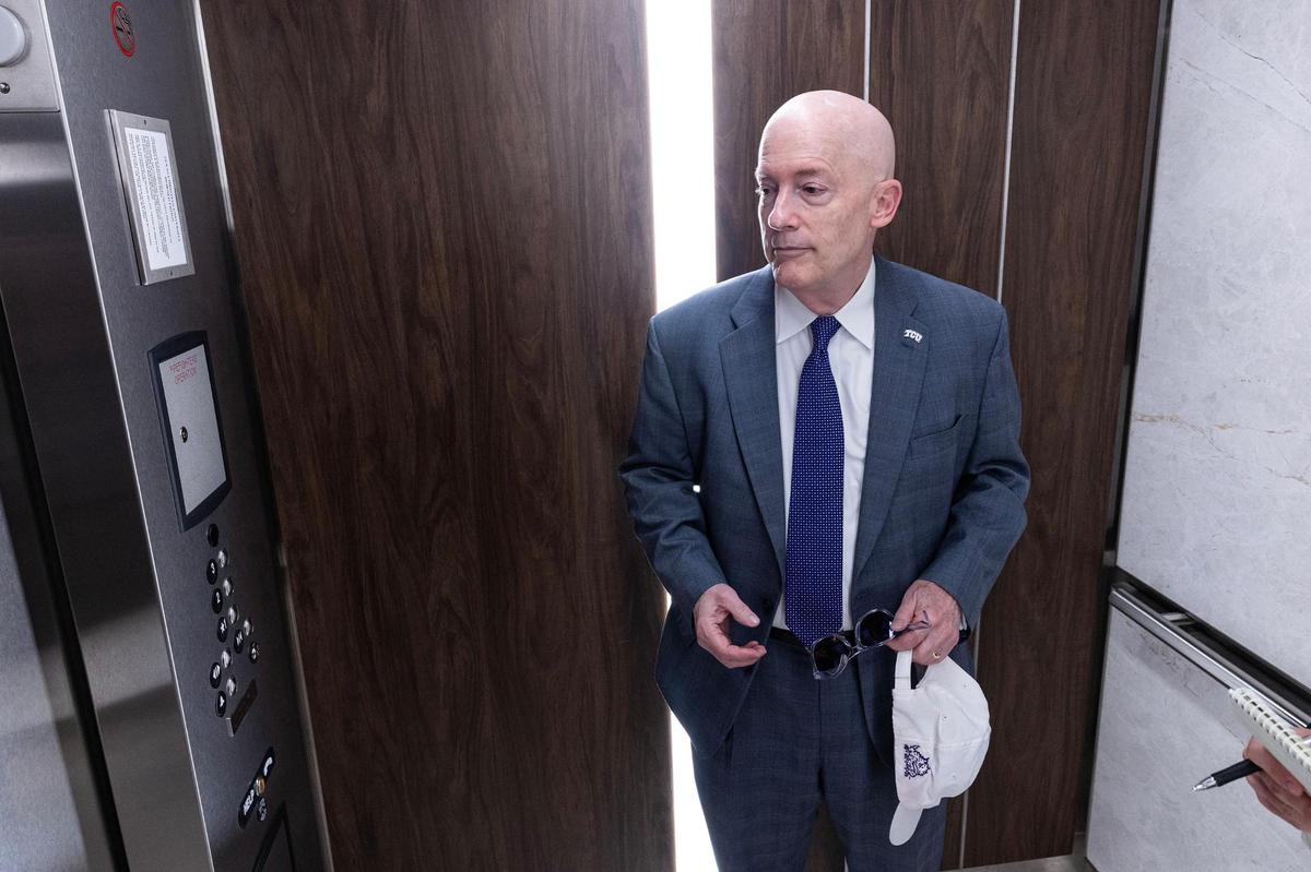 TCU Chancellor Victor Boschini takes the elevator to the ROTC graduation ceremony from his office on Friday, May 9.