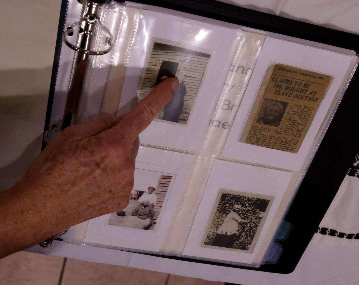 Rebecca Bradshaw points out 100-year-old photos and news articles during “The Conversation: A Story in Black and White” in the sanctuary at the Well Church in Keller on Tuesday, Nov. 12. At the event, Bradshaw met a descendant of a slave owned by her ancestors.
