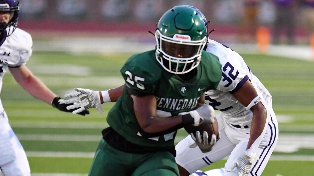 Kennedale’s Jeremiah Clea, front, runs by Alvaredo’s Kaden Ford to go 20 yards and a touchdown that gives the Wildcats a 7-0 lead in the first quarter of Friday’s September 2, 2022 football game at Wildcat Stadium in Kennedale, Texas. Special/Bob Haynes