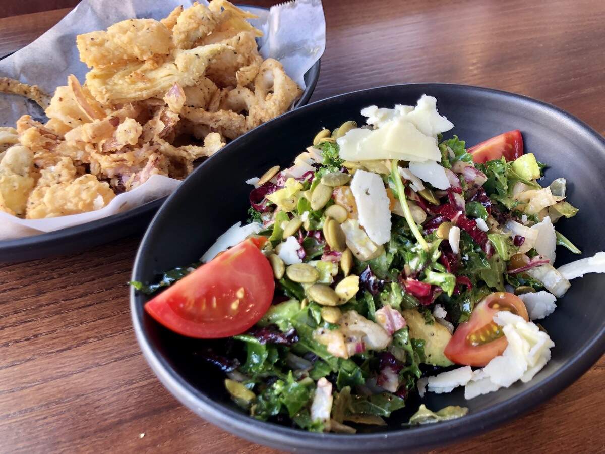 A small side salad and half-price happy-hour calamari at Cork & Pig in Las Colinas.