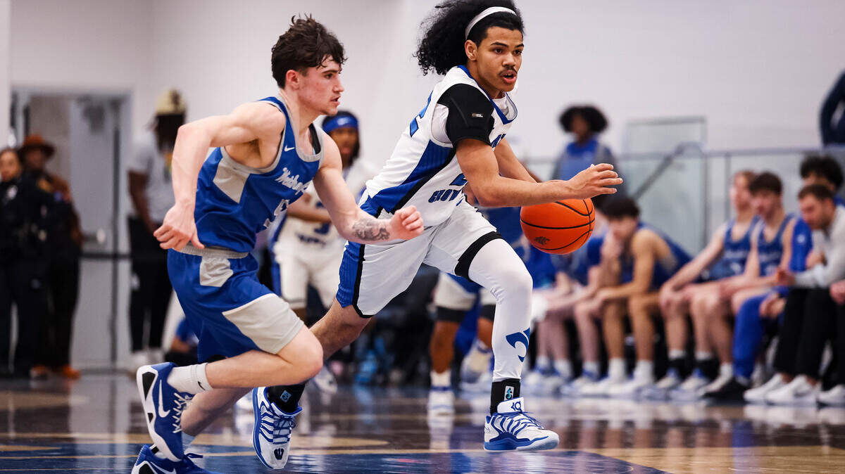 North Crowley guard Isaak Hayes (22) dribbles the ball next to a Weatherford defender in a 3-6A district matchup at North Crowley High School on Friday, Feb. 6, 2026.