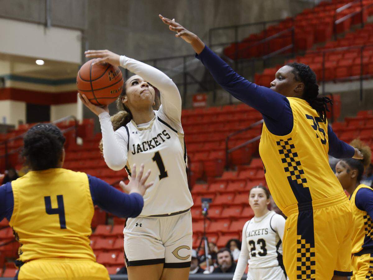 Cleburne forward Lily Sheppard (1) shoots for two against Arlington Heights center Ni'ja Washington (25) during the first half of the UIL 5A D1 girls bi-district championship basketball game at Wilkerson Greines Activity Center in Fort Worth, Texas, Monday Feb. 16, 2026.