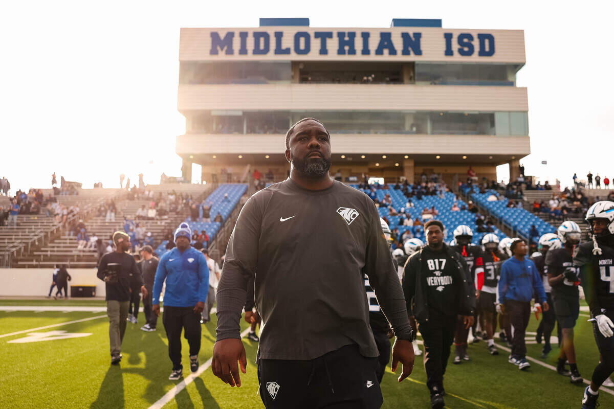 North Crowley head coach Ray Gates walks toward midfield following a 46-21 win over Coppell in a Class 6A Division I regional playoff Saturday at Midlothian ISD Stadium in Midlothian.