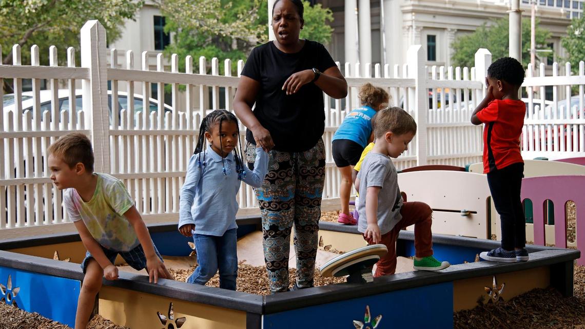 Preschool teacher Tiffany Isaac watches children on the playground at the Rosie K. Mauk Child Development Center in Fort Worth, on Sept. 13, 2023.