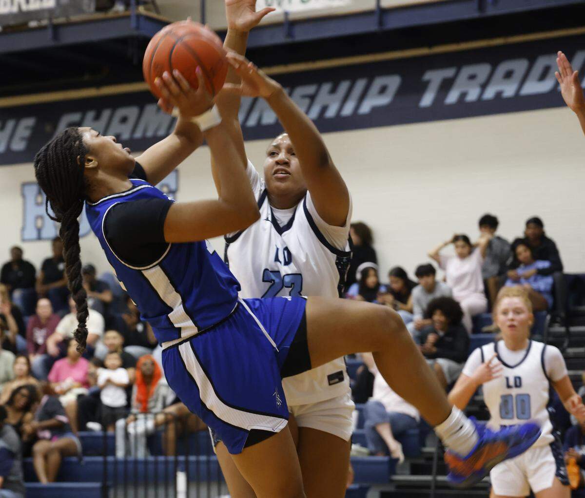 L.D. Bell point Madi Capers (23) fouls Byron Nelson center Belle Ratliff (14) under the net during the first half of a girls UIL basketball game between Byron Nelson and L.D. Bell at L.D. Bell High School in Hurst, Texas, Friday Feb. 06, 2026