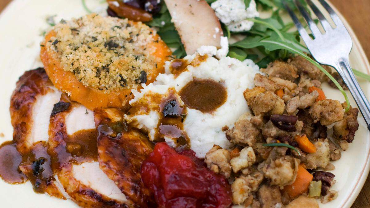FILE- This Oct. 8, 2012, file photo shows a Thanksgiving dinner plate of cider brined turkey with sage gravy, peach cranberry sauce, sour cream and chive mashed potatoes, sausage pecan stuffing, arugula pear salad with pomegranate vinaigrette and goat cheese and herb crusted sweet potatoes in Concord, N.H. (AP Photo/Matthew Mead, File)