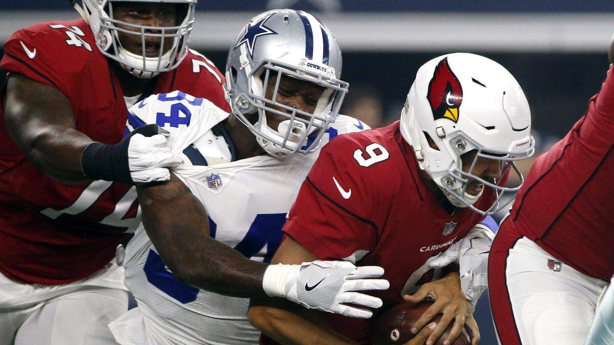 Cardinals quarterback Sam Bradford is sacked by Cowboys defensive end Randy Gregory as D.J. Humphries defends in the first half of Sunday’s preseason game at AT&T Stadium.