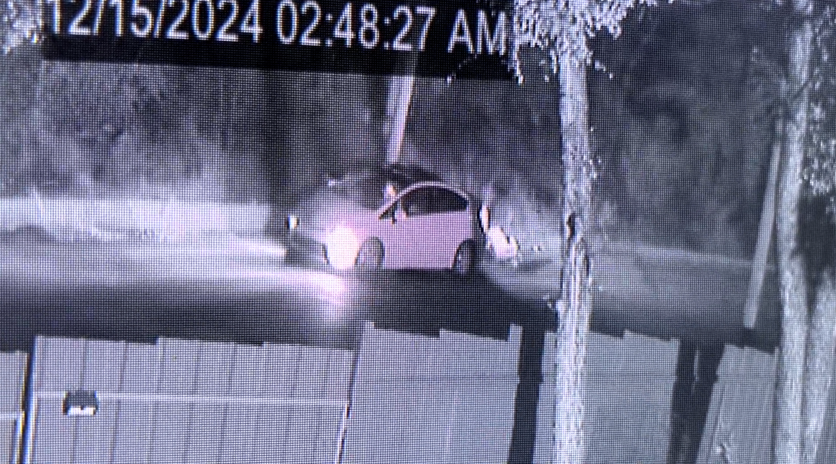 A screenshot of a surveillance video shows a vehicle stopped on Northwest 20th Street and what appears to be a struggle taking place at the rear of the vehicle. 