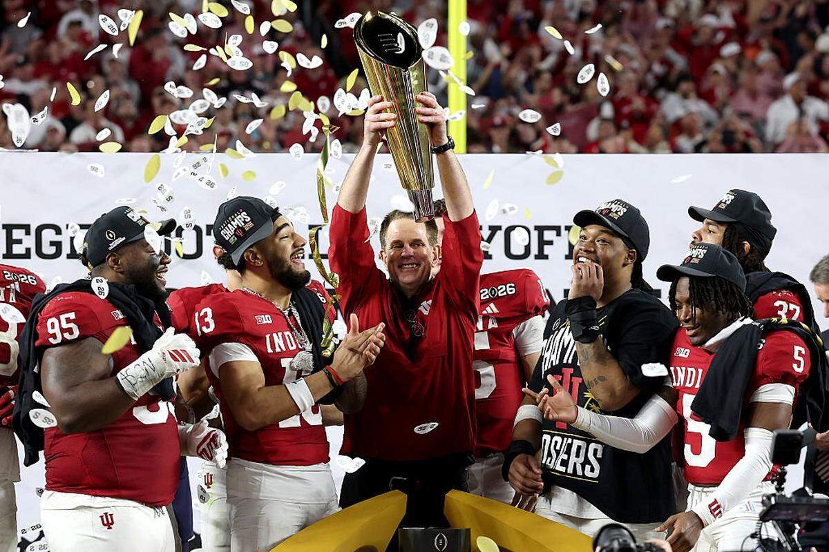 Indiana Hoosiers football coach Curt Cignetti hoists the CFP championship trophy after IU’s 27-21 win over Miami in the Jan. 19, 2026 title game at Hard Rock Stadium in Miami Gardens, Florida.